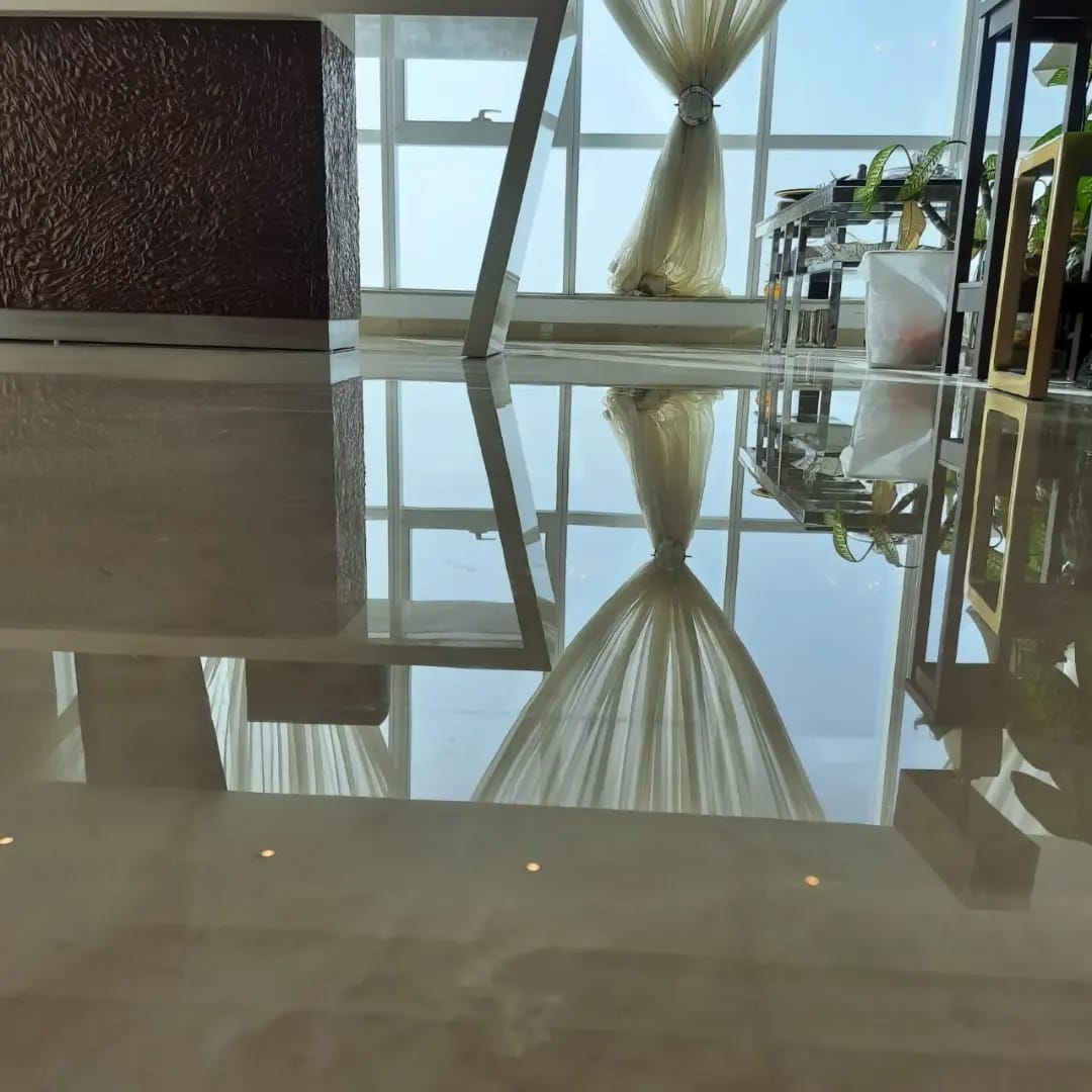 Glossy polished marble floor in Dubai reflecting windows and curtains